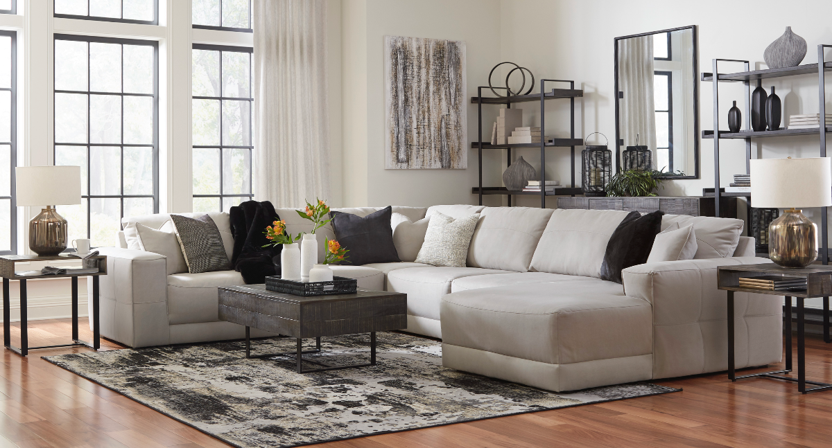 Modern living room with a sectional sofa, coffee table, and decorative items.